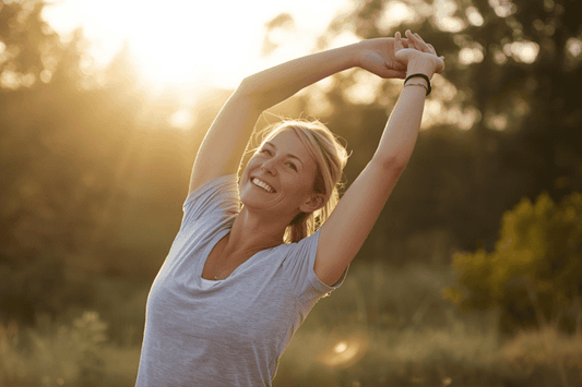 woman outside in nature, stretching with golden light feeling refreshed and full of energy